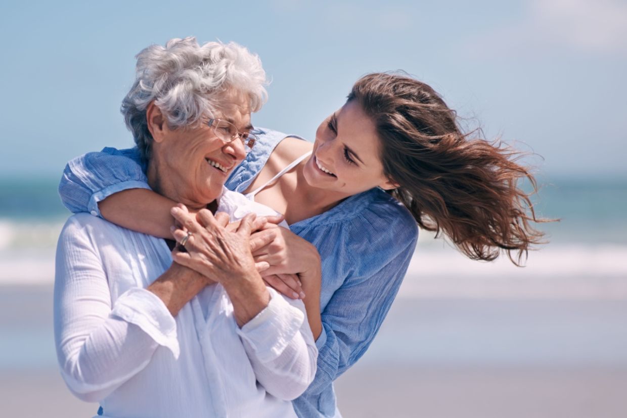 A daughter hugs her mother.